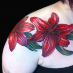 red lily tattoo floral chest piece done by female tattoo artist Jessi Lawson
