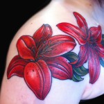 red lily tattoo floral chest piece done by female tattoo artist Jessi Lawson