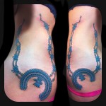 colorful squash blossom necklace tattoo on ribs